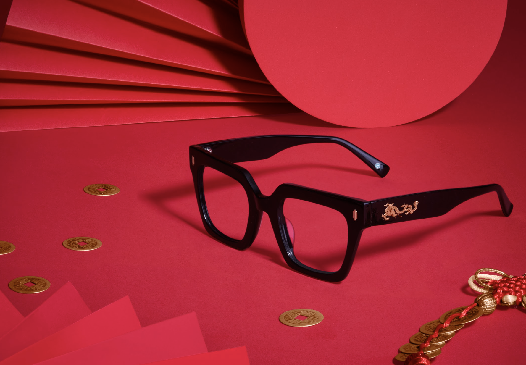 Black square eyeglasses with gold dragon design on temples